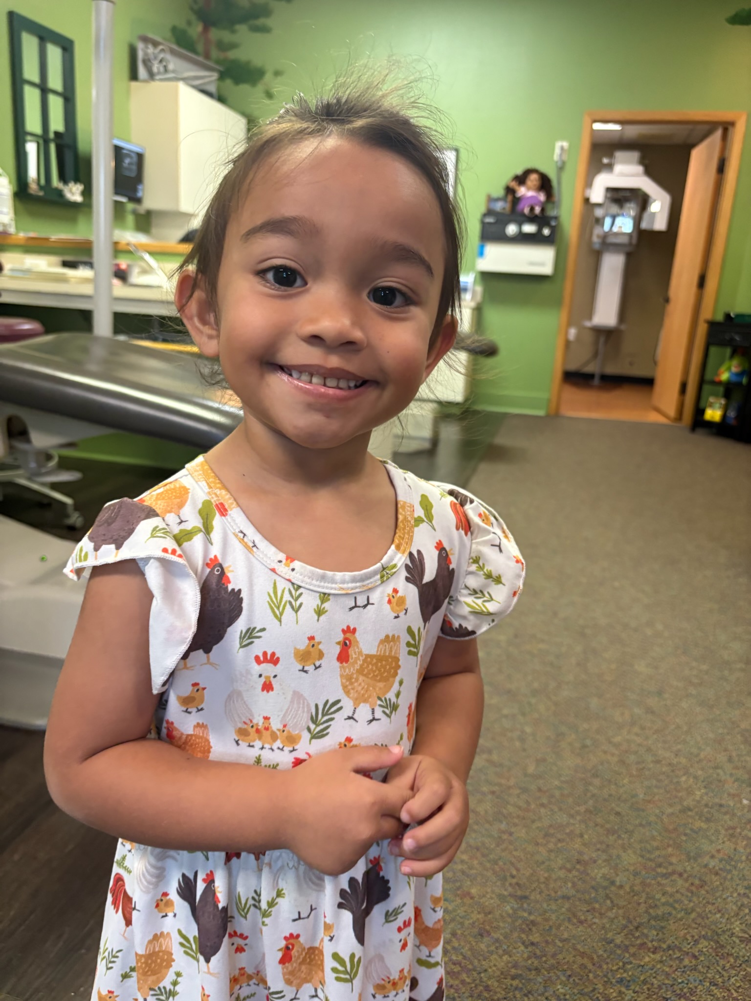 Child celebrating with a No Cavity Club ribbon at Kona Kids Dentist