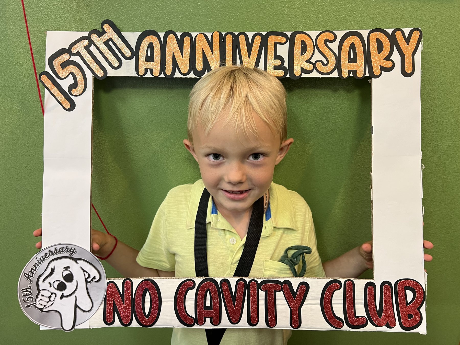 Happy patient celebrating a No Cavity Club milestone at Kona Kids Dentist